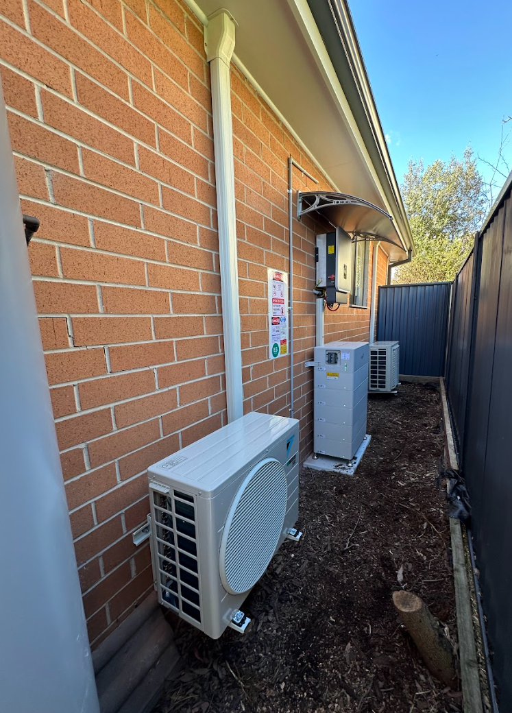 Technician servicing air conditioning unit outdoors
