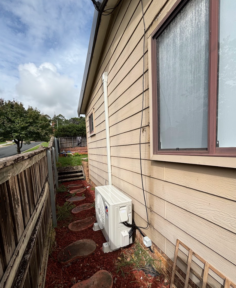 Air conditioning unit beside house exterior